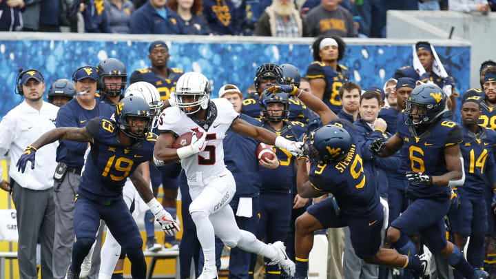 MORGANTOWN, WV – OCTOBER 28: Justice Hill #5 of the Oklahoma State Cowboys rushes against Elijah Battle #19 and Jovanni Stewart #9 of the West Virginia Mountaineers at Mountaineer Field on October 28, 2017 in Morgantown, West Virginia. (Photo by Justin K. Aller/Getty Images)
