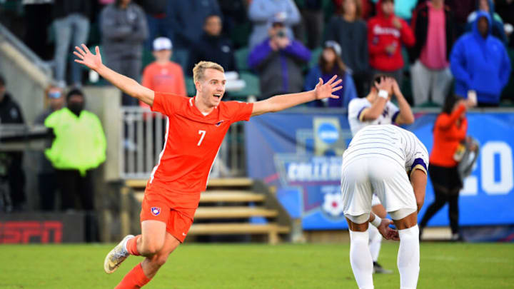 Dec 12, 2021; Cary, NC, USA; Clemson forward Tim Strobeck (7) celebrates as Washington midfielder Kalani Kossa-Rienzi (6) and defender Kendall Burks (2) react at the end of the game at WakeMed Soccer Park. Clemson defeated Washington 2-0. Mandatory Credit: Bob Donnan-USA TODAY Sports
