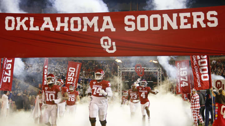 Safety Pat Fields #10, and offensive lineman Marcus Alexander #74 of the Oklahoma Sooners run onto the field for a game against the TCU Horned Frogs. (Photo by Brian Bahr/Getty Images)