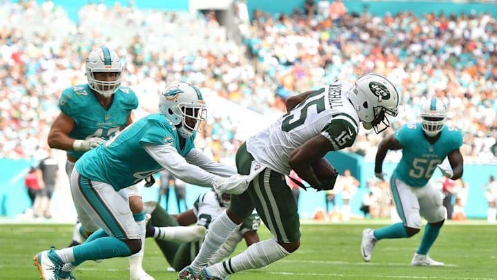 Nov 6, 2016; Miami Gardens, FL, USA; Miami Dolphins cornerback Byron Maxwell (41) tackles New York Jets wide receiver Brandon Marshall (15) during the first half at Hard Rock Stadium. Mandatory Credit: Jasen Vinlove-USA TODAY Sports