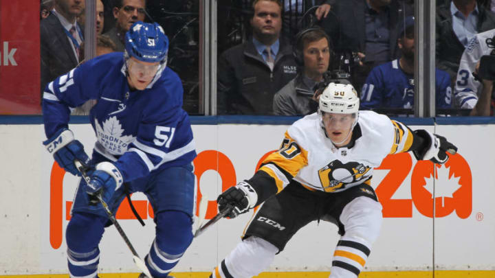 TORONTO, ON - OCTOBER 18: Jake Gardiner #51 of the Toronto Maple Leafs skates the puck against Juuso Riikola #50 of the Pittsburgh Penguins during an NHL game at Scotiabank Arena on October 18, 2018 in Toronto, Ontario, Canada. (Photo by Claus Andersen/Getty Images)