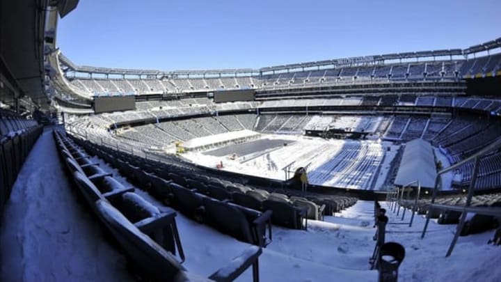 Jan 22, 2014; East Rutherford, NJ, USA; A general view as stadium workers clean snow from the field and stands during the Super Bowl XLVIII stadium preparations press conference at MetLife Stadium. Mandatory Credit: Joe Camporeale-USA TODAY Sports