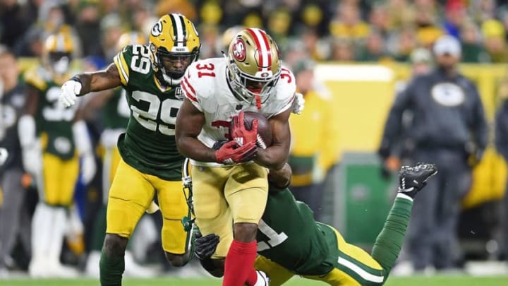 GREEN BAY, WI - OCTOBER 15: Raheem Mostert #31 of the San Francisco 49ers is brought down by Ha Ha Clinton-Dix #21 of the Green Bay Packers during the second quarter at Lambeau Field on October 15, 2018 in Green Bay, Wisconsin. (Photo by Stacy Revere/Getty Images)