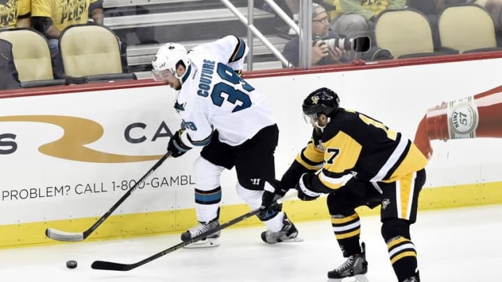 Jun 9, 2016; Pittsburgh, PA, USA; San Jose Sharks center Logan Couture (39) controls the puck against Pittsburgh Penguins right wing Bryan Rust (17) in the second period game five of the 2016 Stanley Cup Final at Consol Energy Center. Mandatory Credit: Don Wright-USA TODAY Sports