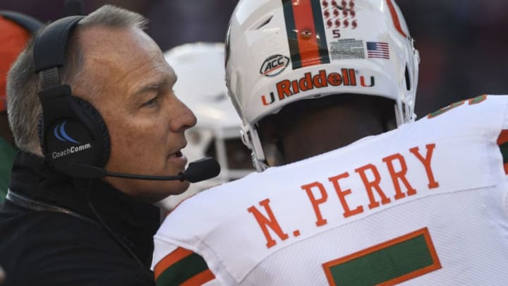 BLACKSBURG, VA - NOVEMBER 17: Head coach Mark Richt of the Miami Hurricanes speaks to quarterback N'Kosi Perry #5 during a timeout against the Virginia Tech Hokies in the first half at Lane Stadium on November 17, 2018 in Blacksburg, Virginia. (Photo by Michael Shroyer/Getty Images)