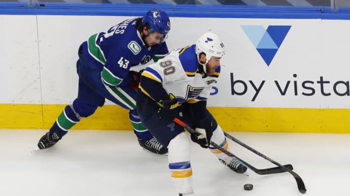 Aug 21, 2020; Edmonton, Alberta, CAN; Vancouver Canucks defenseman Quinn Hughes (43) and St. Louis Blues center Ryan O'Reilly (90) battle for the puck during the second period in game six of the first round of the 2020 Stanley Cup Playoffs at Rogers Place. Mandatory Credit: Perry Nelson-USA TODAY Sports