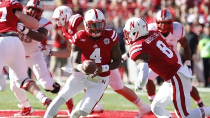 Oct 25, 2014; Lincoln, NE, USA; Nebraska Cornhuskers quarterback Tommy Armstrong Jr. (4) hands off to running back Ameer Abdullah (8) during the game against Rutgers Scarlet Knights in the first half at Memorial Stadium. Mandatory Credit: Bruce Thorson-USA TODAY Sports