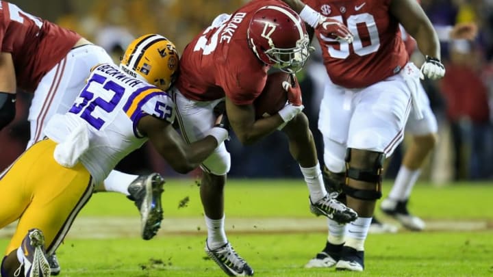 Nov 7, 2015; Tuscaloosa, AL, USA; Alabama Crimson Tide running back Kenyan Drake (17) is brought down by LSU Tigers linebacker Kendell Beckwith (52) during the first quarter at Bryant-Denny Stadium. Mandatory Credit: Marvin Gentry-USA TODAY Sports