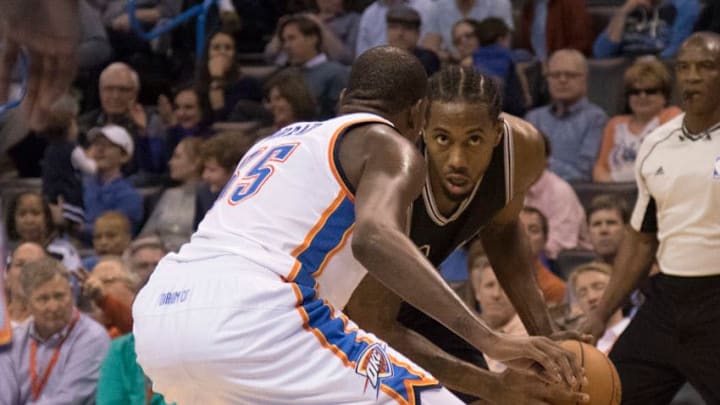 OKLAHOMA CITY, OK - OCTOBER 28: Kevin Durant #35 of the Oklahoma City Thunder tries to block Kawhi Leonard #2 of the San Antonio Spurs during the third quarter of a NBA game at the Chesapeake Energy Center on October 28, 2015 in Oklahoma City, Oklahoma. NOTE TO USER: User expressly acknowledges and agrees that, by downloading and or using this photograph, User is consenting to the terms and conditions of the Getty Images License Agreement. (Photo by J Pat Carter/Getty Images)