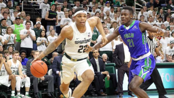 Nov 20, 2016; East Lansing, MI, USA; Michigan State Spartans guard Miles Bridges (22) drives the baseline against Florida Gulf Coast Eagles forward Demetris Morant (21) during the second half of a game at Jack Breslin Student Events Center. Mandatory Credit: Mike Carter-USA TODAY Sports