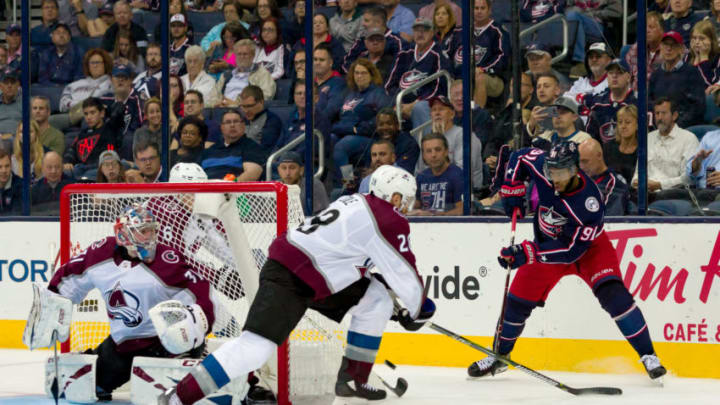 COLUMBUS, OH - OCTOBER 09: Columbus Blue Jackets left wing Anthony Duclair (91) pushes the puck toward the goal as Colorado Avalanche goaltender Philipp Grubauer (31) and Colorado Avalanche defenseman Ian Cole (28) defend in the third period of a game between the Columbus Blue Jackets and the Colorado Avalanche on October 09, 2018 at Nationwide Arena in Columbus, OH. The Blue Jackets won 5-2. (Photo by Adam Lacy/Icon Sportswire via Getty Images)