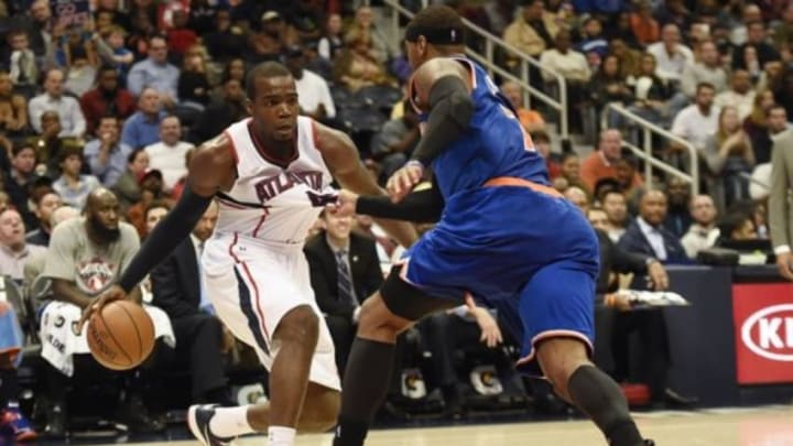 Nov 8, 2014; Atlanta, GA, USA; Atlanta Hawks forward Paul Millsap (4) is grabbed by New York Knicks forward Carmelo Anthony (7) during the second half at Philips Arena. The Hawks defeated the Knicks 103-96. Mandatory Credit: Dale Zanine-USA TODAY Sports