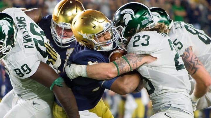 Sep 17, 2016; South Bend, IN, USA; Notre Dame Fighting Irish quarterback DeShone Kizer (14) fights his way into the end zone as Michigan State Spartans linebacker Chris Frey (23) defends in the fourth quarter at Notre Dame Stadium. MSU won 36-28. Mandatory Credit: Matt Cashore-USA TODAY Sports