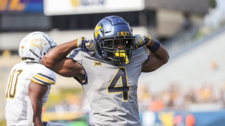 Sep 17, 2022; Morgantown, West Virginia, USA; West Virginia Mountaineers wide receiver Jeremiah Aaron (4) celebrates after catching a touchdown pass during the third quarter against the Towson Tigers at Mountaineer Field at Milan Puskar Stadium. Mandatory Credit: Ben Queen-USA TODAY Sports