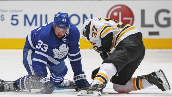 TORONTO, ON - OCTOBER 19: Patrice Bergeron #37 of the Boston Bruins battles against Frederik Gauthier #33 of the Toronto Maple Leafs during an NHL game at Scotiabank Arena on October 19, 2019 in Toronto, Ontario, Canada. The Maple Leafs defeated the Bruins 4-3 in overtime. (Photo by Claus Andersen/Getty Images)