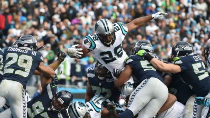 Jan 17, 2016; Charlotte, NC, USA; Carolina Panthers running back Jonathan Stewart (28) scores on a 1 yard touchdown carry over Seattle Seahawks middle linebacker Bobby Wagner (54) and Brock Coyle (52) during the second quarter in a NFC Divisional round playoff game at Bank of America Stadium. Mandatory Credit: Kirby Lee-USA TODAY Sports