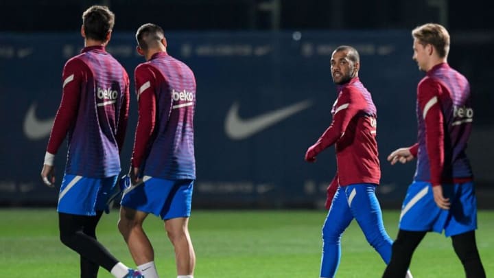 Barcelona defender Dani Alves (C) arrives with teammates for a training session in Barcelona on November 19, 2021, on the eve of their Spanish Liga football match against RCD Espanyol. (Photo by JOSEP LAGO/AFP via Getty Images)