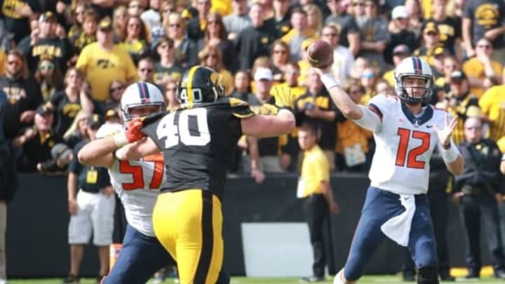 Oct 10, 2015; Iowa City, IA, USA;Illinois Fighting Illini quarterback Wes Lunt (12) is protected by offensive lineman Austin Schmidt (57) as he blocks Iowa Hawkeyes linebacker Parker Hesse (40) in the fourth quarter at Kinnick Stadium. Iowa beat Illinois 29-20. Mandatory Credit: Reese Strickland-USA TODAY Sports