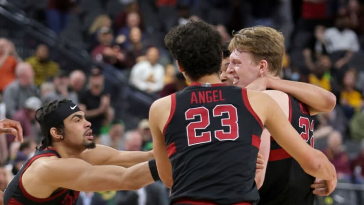 LAS VEGAS, NEVADA - MARCH 09: The Stanford Cardinal celebrate on the court after James Keefe (L) #22 hit a game-winning shot against the Arizona State Sun Devils as time expired in their first-round game of the Pac-12 Conference basketball tournament at T-Mobile Arena on March 09, 2022 in Las Vegas, Nevada. The Cardinal defeated the Sun Devils 71-70. (Photo by Ethan Miller/Getty Images)