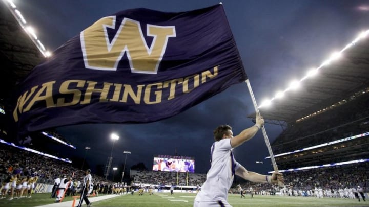 Sep 17, 2016; Seattle, WA, USA; A Washington Huskies cheerleader runs on the field after a touchdown against the Portland State Vikings during the fourth quarter at Husky Stadium. Washington won 41-3. Mandatory Credit: Jennifer Buchanan-USA TODAY Sports