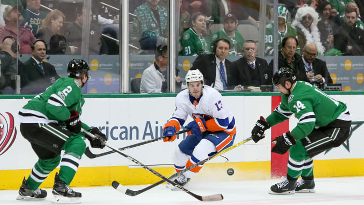 DALLAS, TX – NOVEMBER 10: New York Islanders Center Mathew Barzal (13) plays a puck between Dallas Stars Left Wing Jamie Benn (14) and Defenceman Dan Hamhuis (2) during the NHL hockey game between the New York Islanders and Dallas Stars on November 10, 2017 at American Airlines Center in Dallas, TX. (Photo by Andrew Dieb/Icon Sportswire via Getty Images)