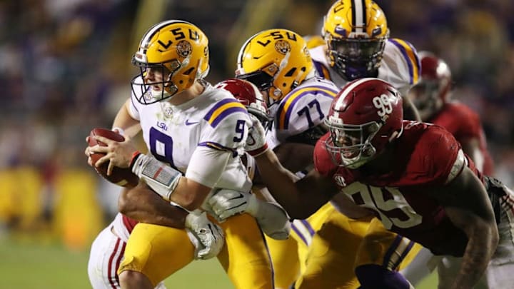 BATON ROUGE, LA - NOVEMBER 03: Joe Burrow #9 of the LSU Tigers tires to avoid a sack by Raekwon Davis #99 of the Alabama Crimson Tide during the second half at Tiger Stadium on November 3, 2018 in Baton Rouge, Louisiana. Alabama won the game 29-0. (Photo by Gregory Shamus/Getty Images) BATON ROUGE, LA - NOVEMBER 03: Joe Burrow #9 of the LSU Tigers tires to avoid a sack by Raekwon Davis #99 of the Alabama Crimson Tide during the second half at Tiger Stadium on November 3, 2018 in Baton Rouge, Louisiana. Alabama won the game 29-0. (Photo by Gregory Shamus/Getty Images)