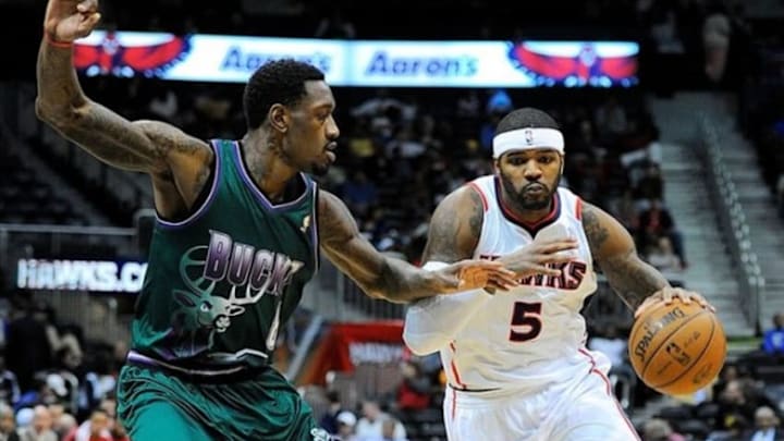 Mar 20, 2013; Atlanta, GA, USA; Atlanta Hawks small forward Josh Smith (5) brings the ball past Milwaukee Bucks center Larry Sanders (8) during the second half at Philips Arena. The Hawks defeated the Bucks 98-90. Mandatory Credit: Dale Zanine-USA TODAY Sports