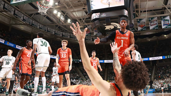 EAST LANSING, MI - FEBRUARY 19: Andre Curbelo #5 of the Illinois Fighting Illini falls to the floor and helped up by teammate Trent Frazier #1 of the Illinois Fighting Illini in the second half of the game against the Michigan State Spartans at Breslin Center on February 19, 2022 in East Lansing, Michigan. (Photo by Rey Del Rio/Getty Images)