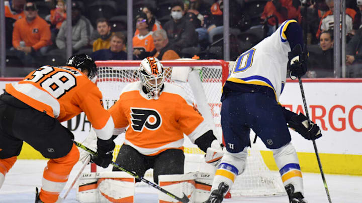 Feb 22, 2022; Philadelphia, Pennsylvania, USA; Philadelphia Flyers center Patrick Brown (38) and goaltender Martin Jones (35) battle against St. Louis Blues center Ryan O'Reilly (90) during the first period at Wells Fargo Center. Mandatory Credit: Eric Hartline-USA TODAY Sports