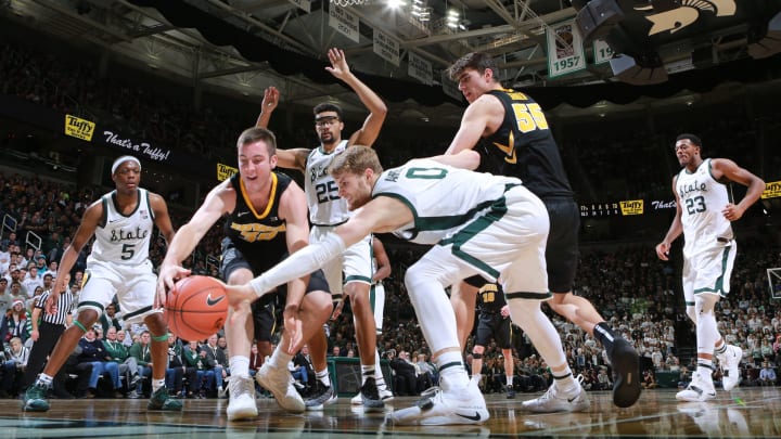 EAST LANSING, MI – DECEMBER 03: Connor McCaffery #30 of the Iowa Hawkeyes fight for a loose ball against Kyle Ahrens #0 of the Michigan State Spartans at Breslin Center on December 3, 2018 in East Lansing, Michigan. (Photo by Rey Del Rio/Getty Images)