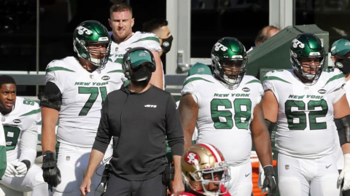 EAST RUTHERFORD, NEW JERSEY - SEPTEMBER 20: (NEW YORK DAILIES OUT) Head coach Adam Gase of the New York Jets looks on from the sidelines along with Alex Lewis #71, Josh Andrews #68 and Greg Van Roten #62 during a game against the San Francisco 49ers at MetLife Stadium on September 20, 2020 in East Rutherford, New Jersey. The 49ers defeated the Jets 31-13. (Photo by Jim McIsaac/Getty Images)