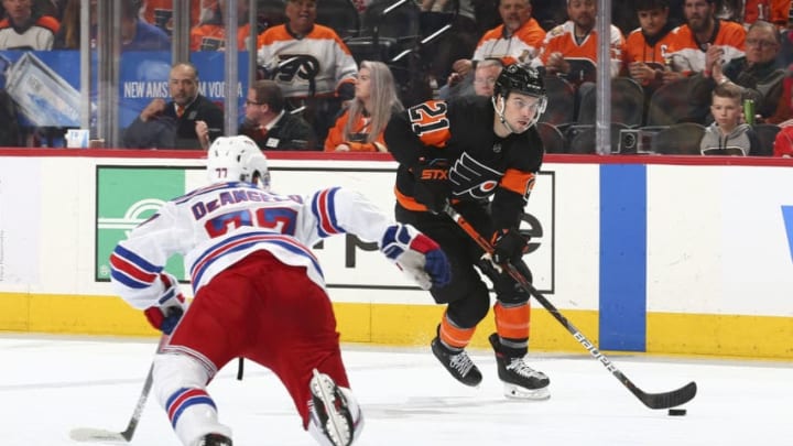 PHILADELPHIA, PA - FEBRUARY 28: Scott Laughton #21 of the Philadelphia Flyers controls the puck against Tony DeAngelo #77 of the New York Rangers in the third period at the Wells Fargo Center on February 28, 2020 in Philadelphia, Pennsylvania. The Flyers defeated the Rangers 5-2. (Photo by Mitchell Leff/Getty Images)
