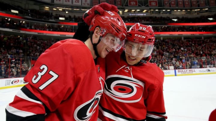 RALEIGH, NC - MARCH 24: Andrei Svechnikov #37 of the Carolina Hurricanes scores the game winning goal in overtime and is congratulated by teammate Teuvo Teravainen #86 during an NHL game agains the Montreal Canadiens on March 24, 2019 at PNC Arena in Raleigh, North Carolina. (Photo by Gregg Forwerck/NHLI via Getty Images)