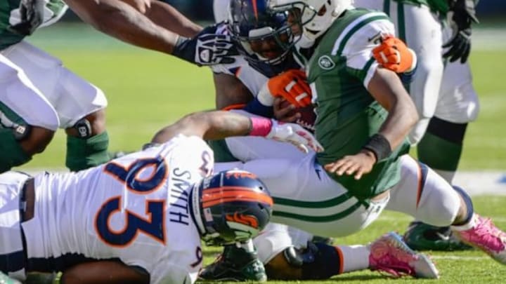 Oct 12, 2014; East Rutherford, NJ, USA; Denver Broncos outside linebacker Von Miller (58) and defensive end Quanterus Smith (93) sack New York Jets quarterback Geno Smith (7) during the second half at MetLife Stadium. Mandatory Credit: Robert Deutsch-USA TODAY Sports