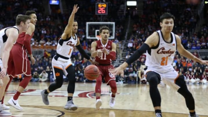 KANSAS CITY, MO – MARCH 07: Oklahoma Sooners guard Trae Young (11) makes a no look pass between Oklahoma State Cowboys guards Kendall Smith (1) and Lindy Waters III (21) in the first half of a first round matchup in the Big 12 Basketball Championship between the Oklahoma Sooners and Oklahoma State Cowboys on March 7, 2018 at Sprint Center in Kansas City, MO. (Photo by Scott Winters/Icon Sportswire via Getty Images)