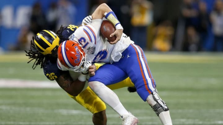 ATLANTA, GEORGIA - DECEMBER 29: Feleipe Franks #13 of the Florida Gators is tackled by Devin Gil #36 of the Michigan Wolverines during the Chick-fil-A Peach Bowl at Mercedes-Benz Stadium on December 29, 2018 in Atlanta, Georgia. (Photo by Mike Zarrilli/Getty Images)
