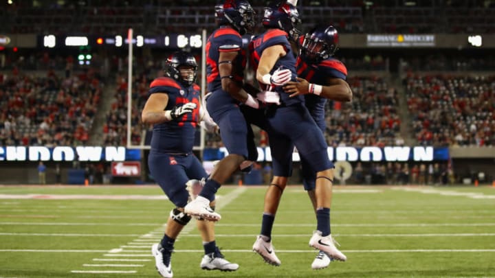 TUCSON, AZ - NOVEMBER 02: Wide receiver Shawn Poindexter #19 and quarterback Khalil Tate #14 of the Arizona Wildcats celebrate after Poindexter caught a one yard touchdown reception against the Colorado Buffaloes during the first half of the college football game at Arizona Stadium on November 2, 2018 in Tucson, Arizona. (Photo by Christian Petersen/Getty Images)