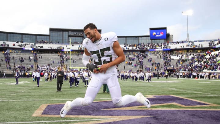 SEATTLE, WASHINGTON - OCTOBER 19: Troy Dye #35 of the Oregon Ducks celebrates after defeating the Washington Huskies 35-31 during their game at Husky Stadium on October 19, 2019 in Seattle, Washington. (Photo by Abbie Parr/Getty Images)