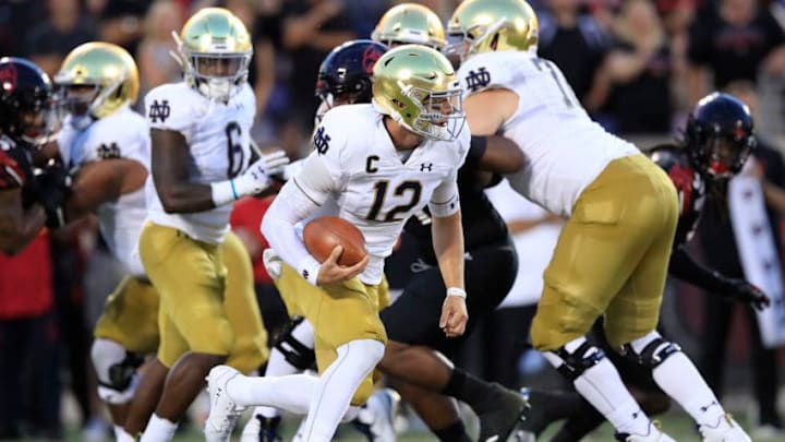 LOUISVILLE, KENTUCKY - SEPTEMBER 02: Ian Book #12 of the Notre Dame Fighting Irish runs with the ball against the Louisville Cardinals on September 02, 2019 in Louisville, Kentucky. (Photo by Andy Lyons/Getty Images)