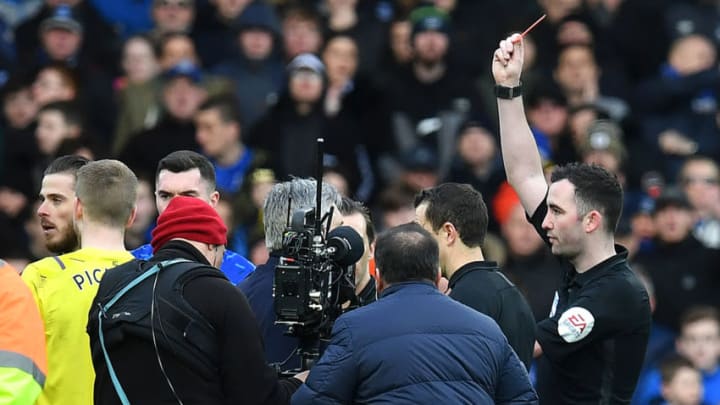 Referee Chris Kavanagh (R) shows a red card to shows a red card to (obstructed) during the English Premier League football match between Everton and Manchester United at Goodison Park in Manchester United, north west England on March 1, 2020. (Photo by Paul ELLIS / AFP) / RESTRICTED TO EDITORIAL USE. No use with unauthorized audio, video, data, fixture lists, club/league logos or 'live' services. Online in-match use limited to 120 images. An additional 40 images may be used in extra time. No video emulation. Social media in-match use limited to 120 images. An additional 40 images may be used in extra time. No use in betting publications, games or single club/league/player publications. / (Photo by PAUL ELLIS/AFP via Getty Images)
