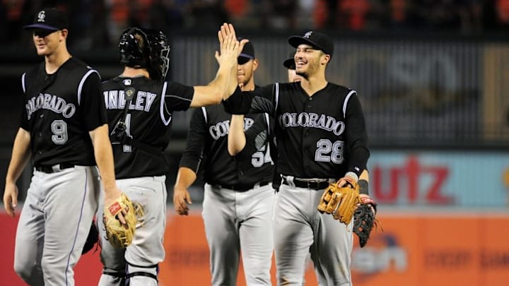Jul 26, 2016; Baltimore, MD, USA; Colorado Rockies third baseman Nolan Arenado (28) high fives teammates after beating the Baltimore Orioles 6-3 at Oriole Park at Camden Yards. Mandatory Credit: Evan Habeeb-USA TODAY Sports