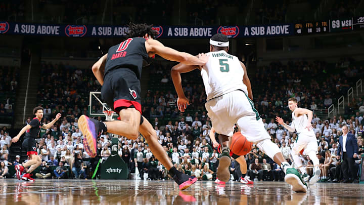 EAST LANSING, MI – FEBRUARY 20: Cassius Winston #5 of the Michigan State Spartans dribbles up the court and draws a foul from Geo Baker #0 of the Rutgers Scarlet Knights in the second half at Breslin Center on February 20, 2019 in East Lansing, Michigan. (Photo by Rey Del Rio/Getty Images)