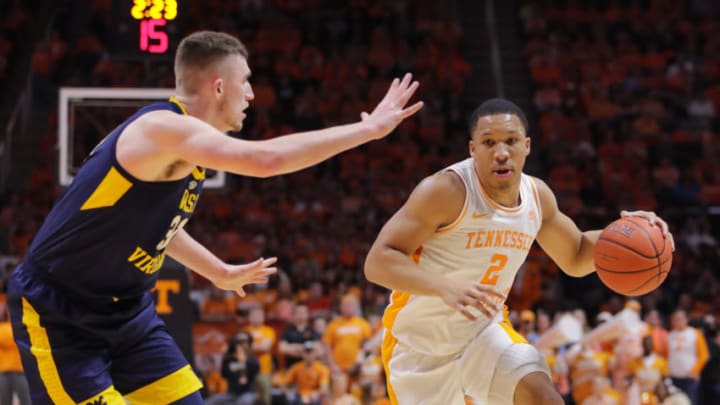 KNOXVILLE, TN - JANUARY 26: Grant Williams #2 of the Tennessee Volunteers dribbles around Logan Routt #31 of the West Virginia Mountaineers during their game at Thompson-Boling Arena on January 26, 2019 in Knoxville, Tennessee. (Photo by Donald Page/Getty Images)