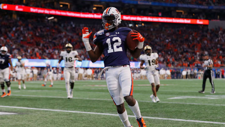 ATLANTA, GA – JANUARY 01: Eli Stove #12 of the Auburn Tigers rushes for a touchdown in the fourth quarter against the UCF Knights during the Chick-fil-A Peach Bowl at Mercedes-Benz Stadium on January 1, 2018 in Atlanta, Georgia. (Photo by Kevin C. Cox/Getty Images)