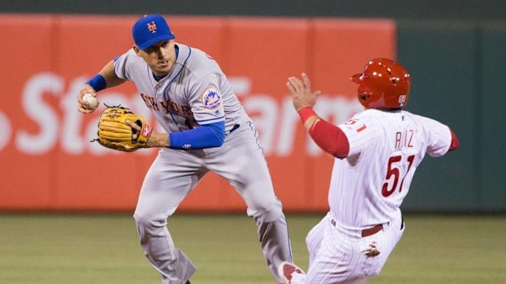 Apr 20, 2016; Philadelphia, PA, USA; Philadelphia Phillies catcher Carlos Ruiz (51) breaks up the double play throw attempt of New York Mets shortstop Asdrubal Cabrera (13) during the fourth inning at Citizens Bank Park. Mandatory Credit: Bill Streicher-USA TODAY Sports