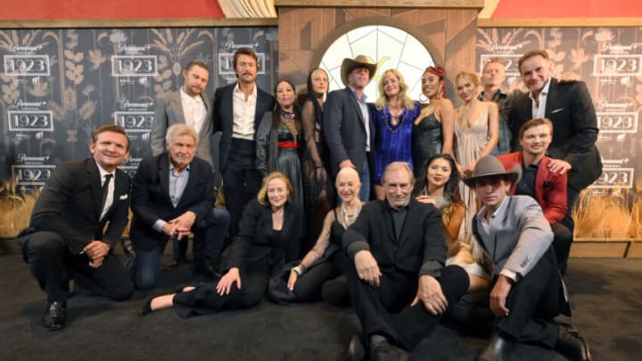 LAS VEGAS, NEVADA - DECEMBER 03: (Front Row L-R) Sebastian Roché, Harrison Ford, Jennifer Ehle, Helen Mirren, Timothy Dalton, Leenah Robinson, Caleb Martin and Darren Mann (back row L-R) Brian Geraghty, Brandon Sklenar, Amelia Rico, Julia Schlaepfer, Taylor Sheridan, Marley Shelton, Aminah Nieves, Michelle Randolph, James Badge Dale and Tim DeKay attend the "1923" Las Vegas premiere screening the Encore Theater at Wynn Las Vegas on December 03, 2022 in Las Vegas, Nevada. (Photo by David Becker/Getty Images for Paramount+)