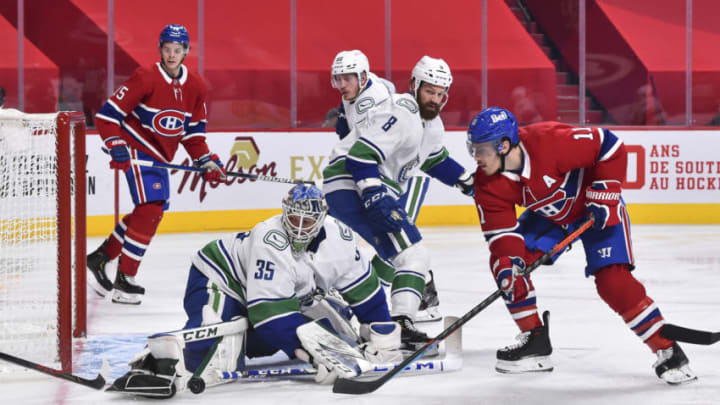 MONTREAL, QC - FEBRUARY 02: Goaltender Thatcher Demko #35 of the Vancouver Canucks makes a save near Brendan Gallagher #11 of the Montreal Canadiens during the second period at the Bell Centre on February 2, 2021 in Montreal, Canada. (Photo by Minas Panagiotakis/Getty Images)