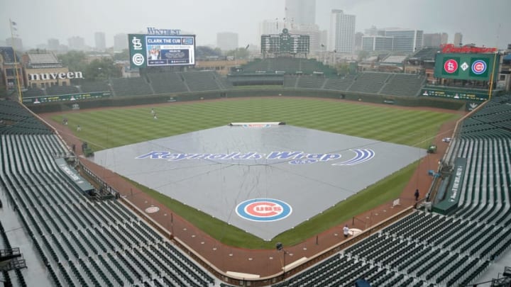 CHICAGO, IL - JULY 20: The tarp sits on the field before the game between the Chicago Cubs and the St. Louis Cardinals as rain moves through the area at Wrigley Field on July 20, 2018 in Chicago, Illinois. (Photo by Jon Durr/Getty Images)