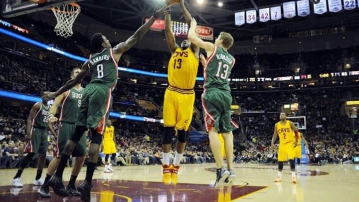 Jan 24, 2014; Cleveland, OH, USA; Cleveland Cavaliers forward Tristan Thompson (13) fights for a rebound with Milwaukee Bucks guard Luke Ridnour (13) and Milwaukee Bucks center Larry Sanders (8) during the third quarter at Quicken Loans Arena. The Cavaliers beat the Bucks 93-78. Mandatory Credit: Ken Blaze-USA TODAY Sports