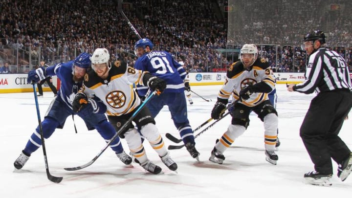 David Pastrnak #88 of the Boston Bruins battles against Jake Muzzin #8 of the Toronto Maple Leafs in Game Three of the Eastern Conference First Round during the 2019 NHL Stanley Cup Playoffs at Scotiabank Arena. (Photo by Claus Andersen/Getty Images)